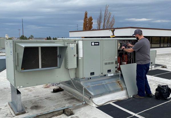 tech working on roof unit