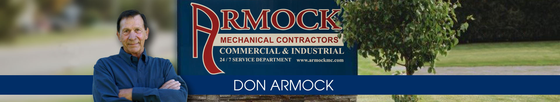 Founder Don Armock photo w/ bldg sign