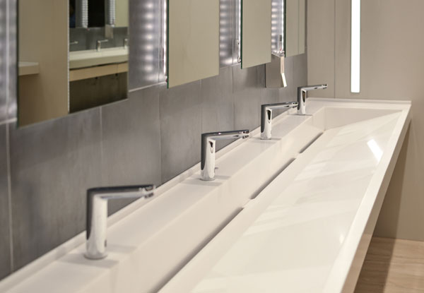 commercial restroom row of sinks & faucets