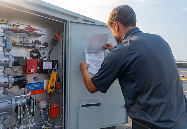 service tech performing a corrective repair on rooftop unit