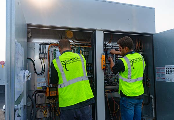 Service technicians working on a rooftop unit